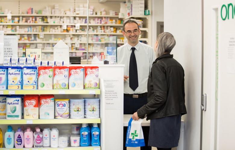 woman talking to male pharmacist