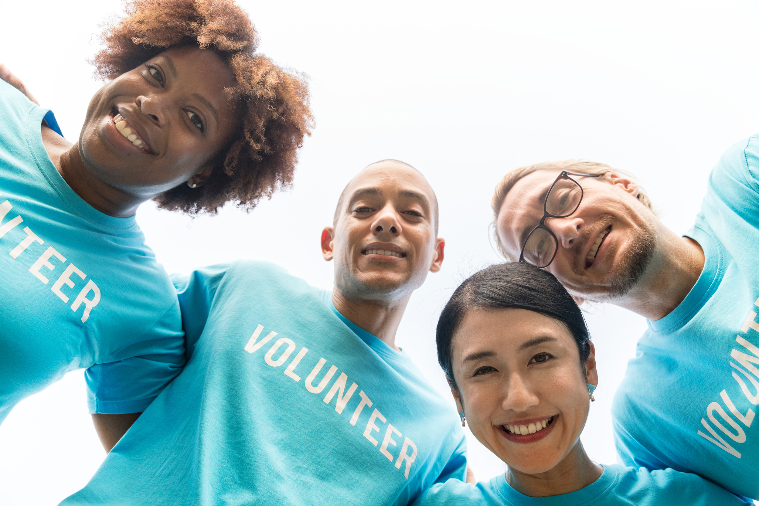 group of people wearing blue t-shirts with volunteer written on the front