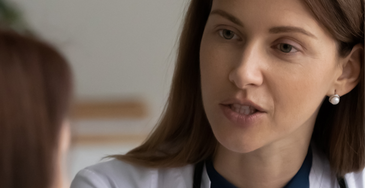 female doctor wearing stethoscope talking to patient