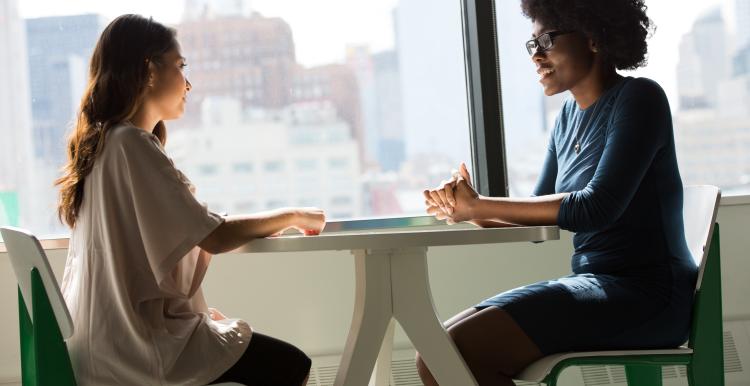 two people sat facing each other at a table