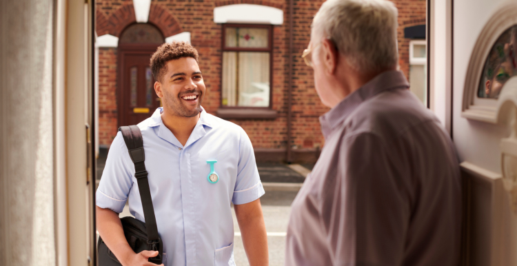 volunteer stood on older man's doorstep