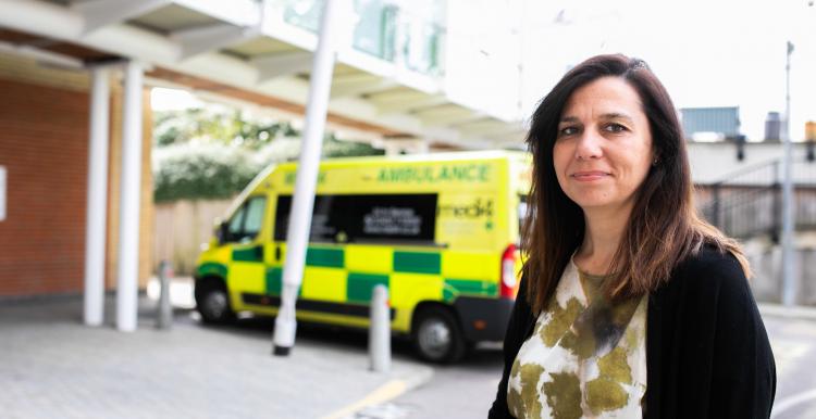 woman standing in front of ambulance