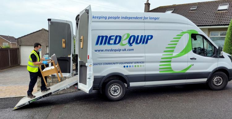 man loading chair onto Medequip van