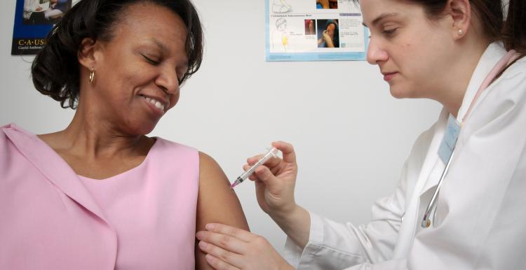 woman being vaccinated by nurse