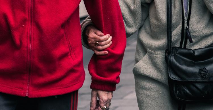 two people walking hand in arm