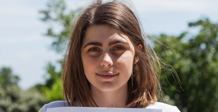 girl holding piece of paper