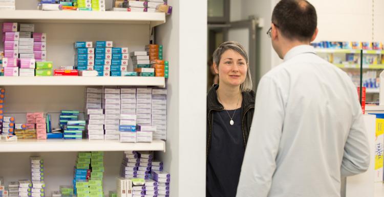 woman talking to male pharmacist