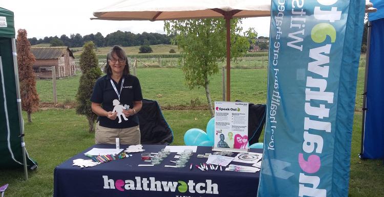 volunteer at information stand