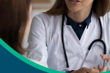 female doctor wearing stethoscope talking to patient