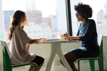 two people sat facing each other at a table