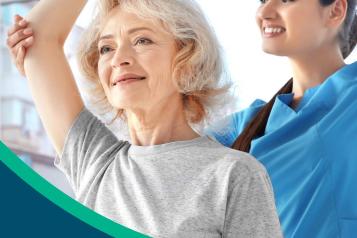 Female nurse in blue scrubs helps older female patient to stretch arm upwards