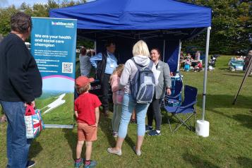 Healthwatch stand surrounded by people at Amesbury Super Fete