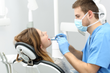 male dentist and female patient in chair