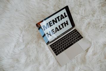 The words mental health on laptop screen