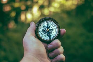 person holding compass