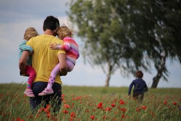 family walking through field