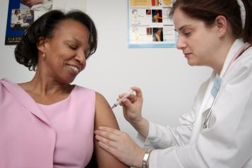woman being vaccinated by nurse