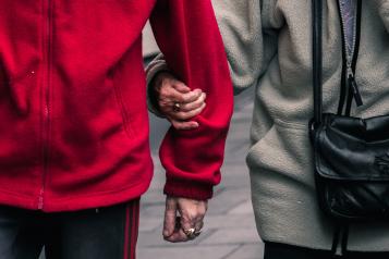 two people walking hand in arm