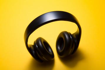 black headphones on a yellow background