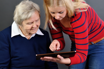 two women looking at a tablet