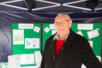male volunteer promoting healthwatch at an event