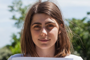 girl holding piece of paper