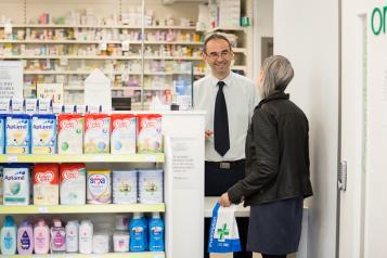 woman talking to male pharmacist