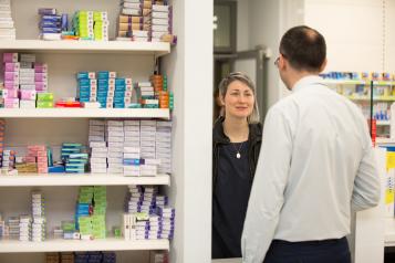 woman talking to male pharmacist