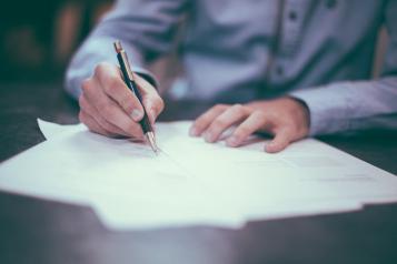 person filling in paperwork