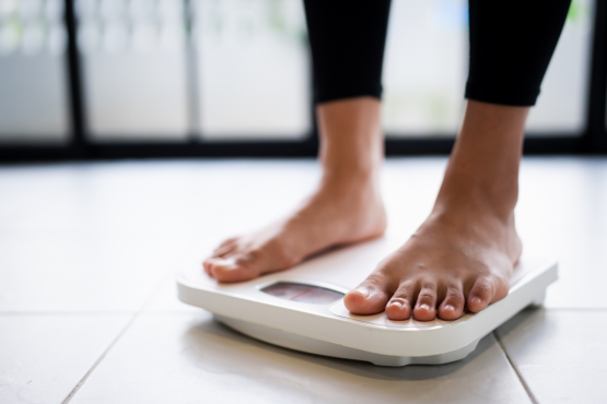 Bare feet on a weighing scale.