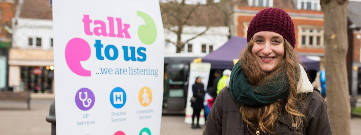 volunteer stood outside next to pull up banner