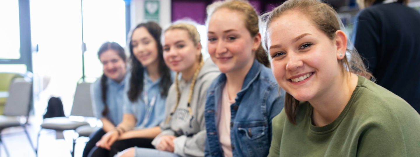 group of girls sitting in a row